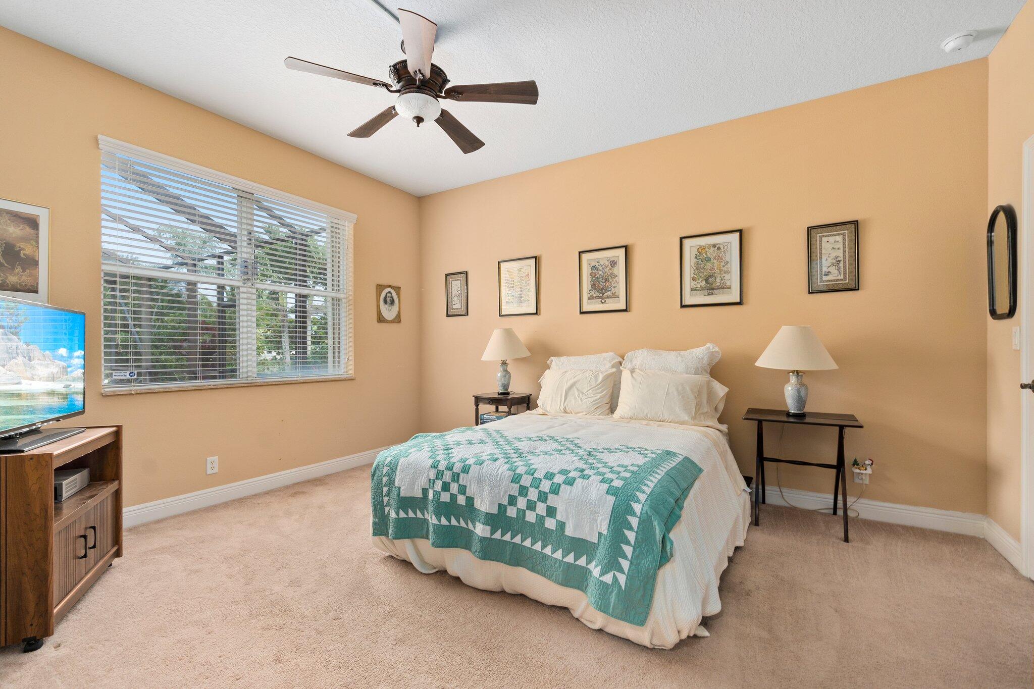 2309 Southwest Ivory Road Port St. Lucie, FL 34953 - Photo 19 of 46 a bedroom with a bed and a window