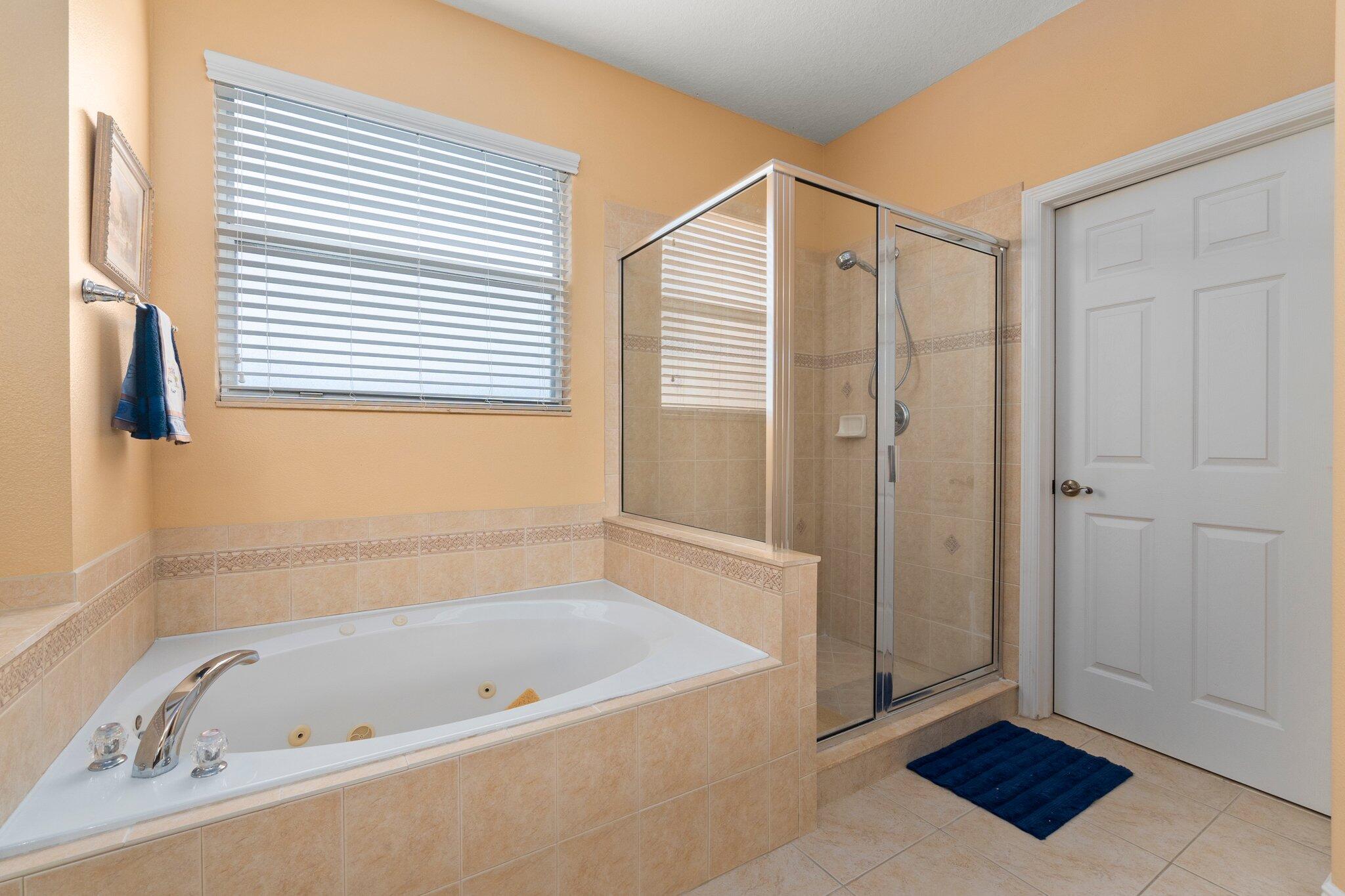 2309 Southwest Ivory Road Port St. Lucie, FL 34953 - Photo 27 of 46 a bathroom with a bathtub and a shower
