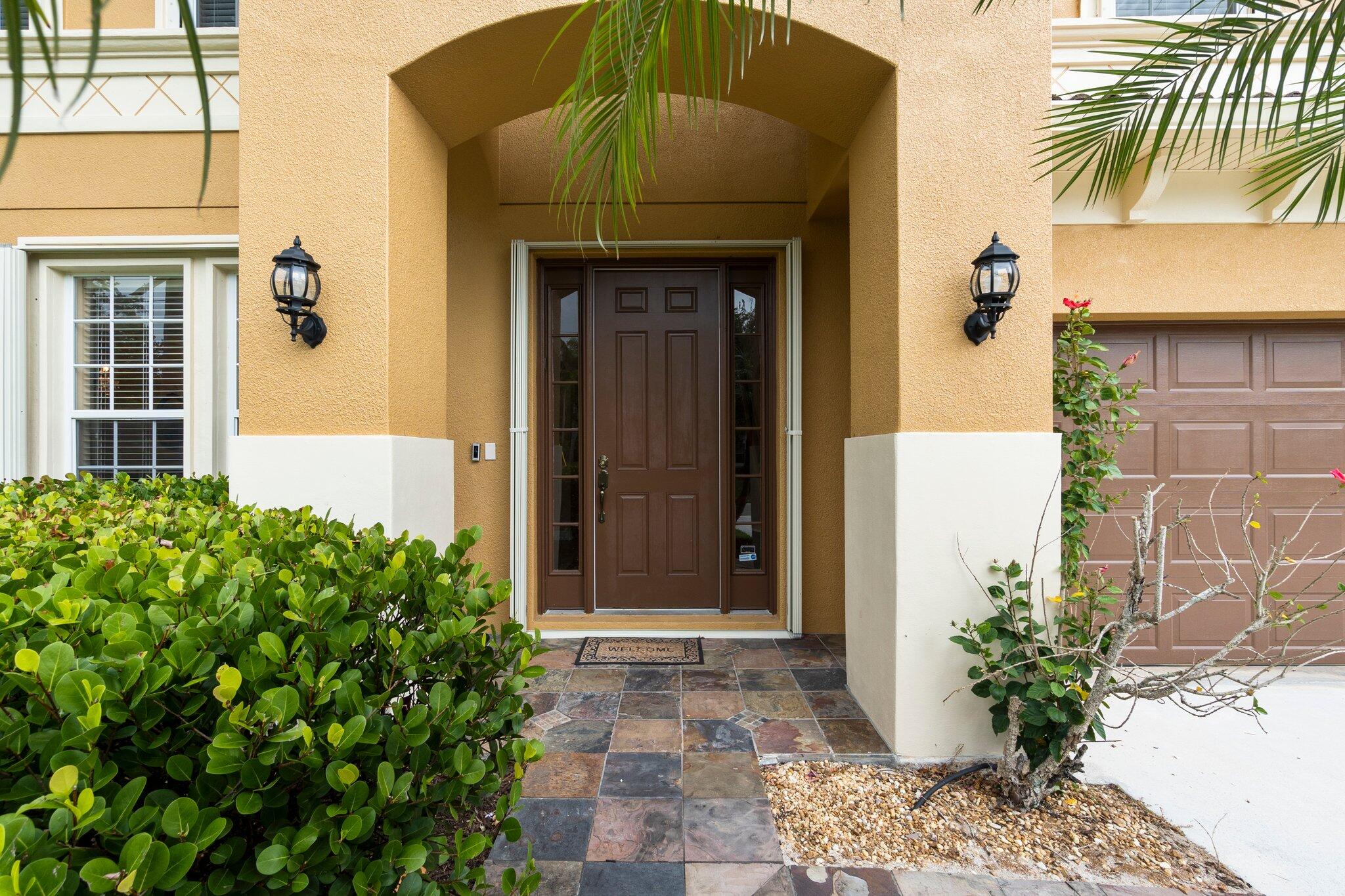 2309 Southwest Ivory Road Port St. Lucie, FL 34953 - Photo 3 of 46 a front view of a house with a garden