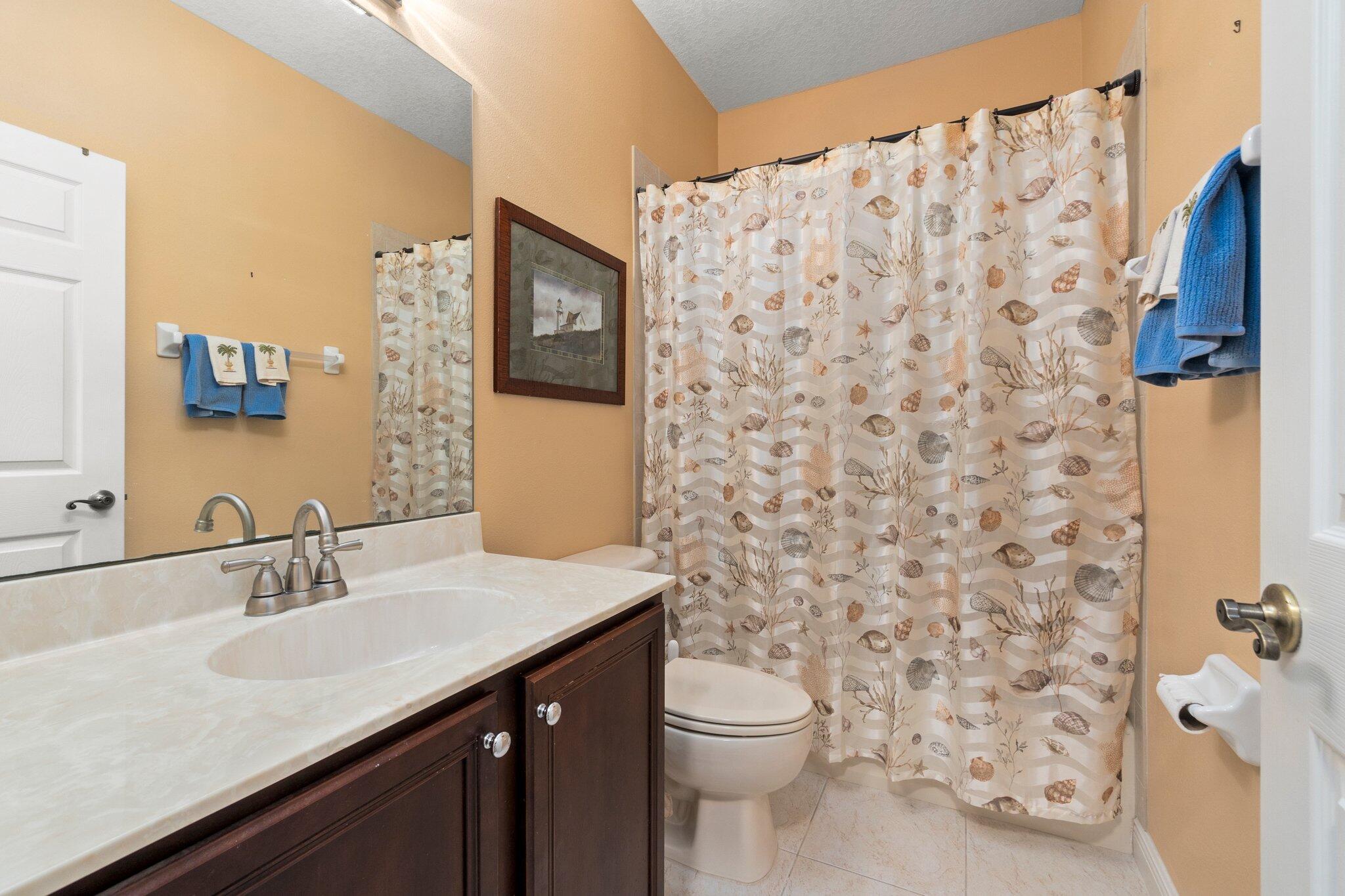 2309 Southwest Ivory Road Port St. Lucie, FL 34953 - Photo 31 of 46 a bathroom with a sink toilet and shower