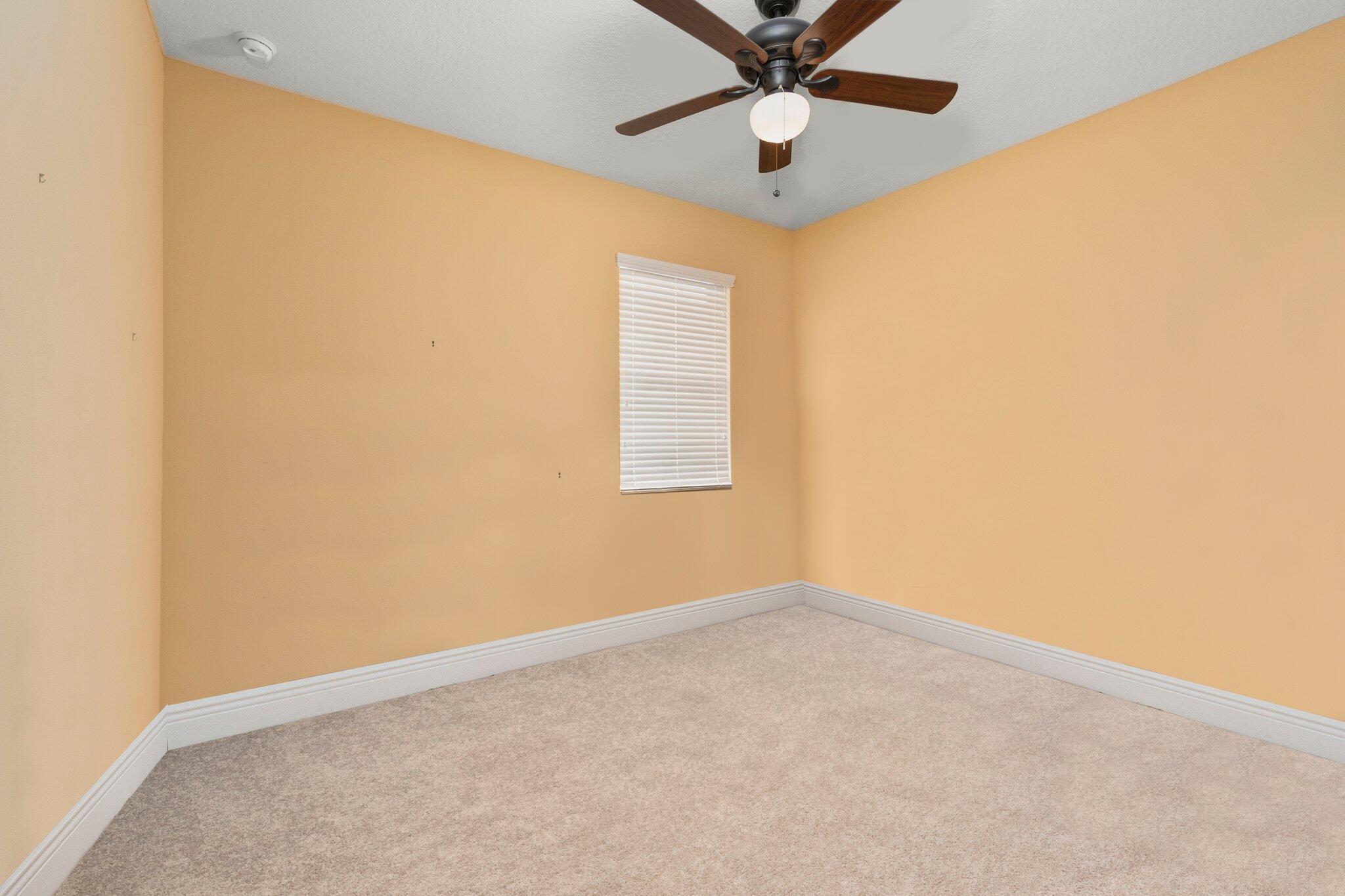 2309 Southwest Ivory Road Port St. Lucie, FL 34953 - Photo 32 of 46 an empty room with a window and a fan