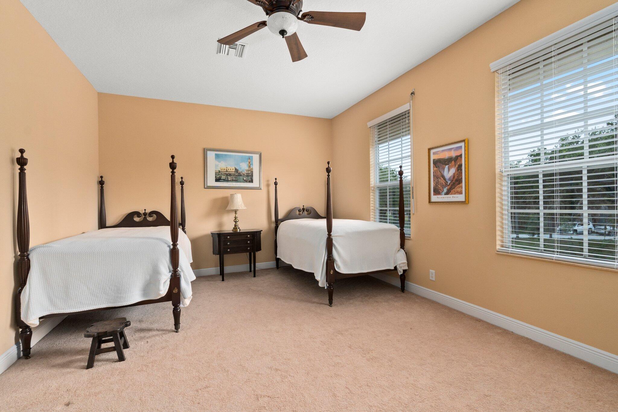 2309 Southwest Ivory Road Port St. Lucie, FL 34953 - Photo 33 of 46 a bedroom with a bed and wooden floor