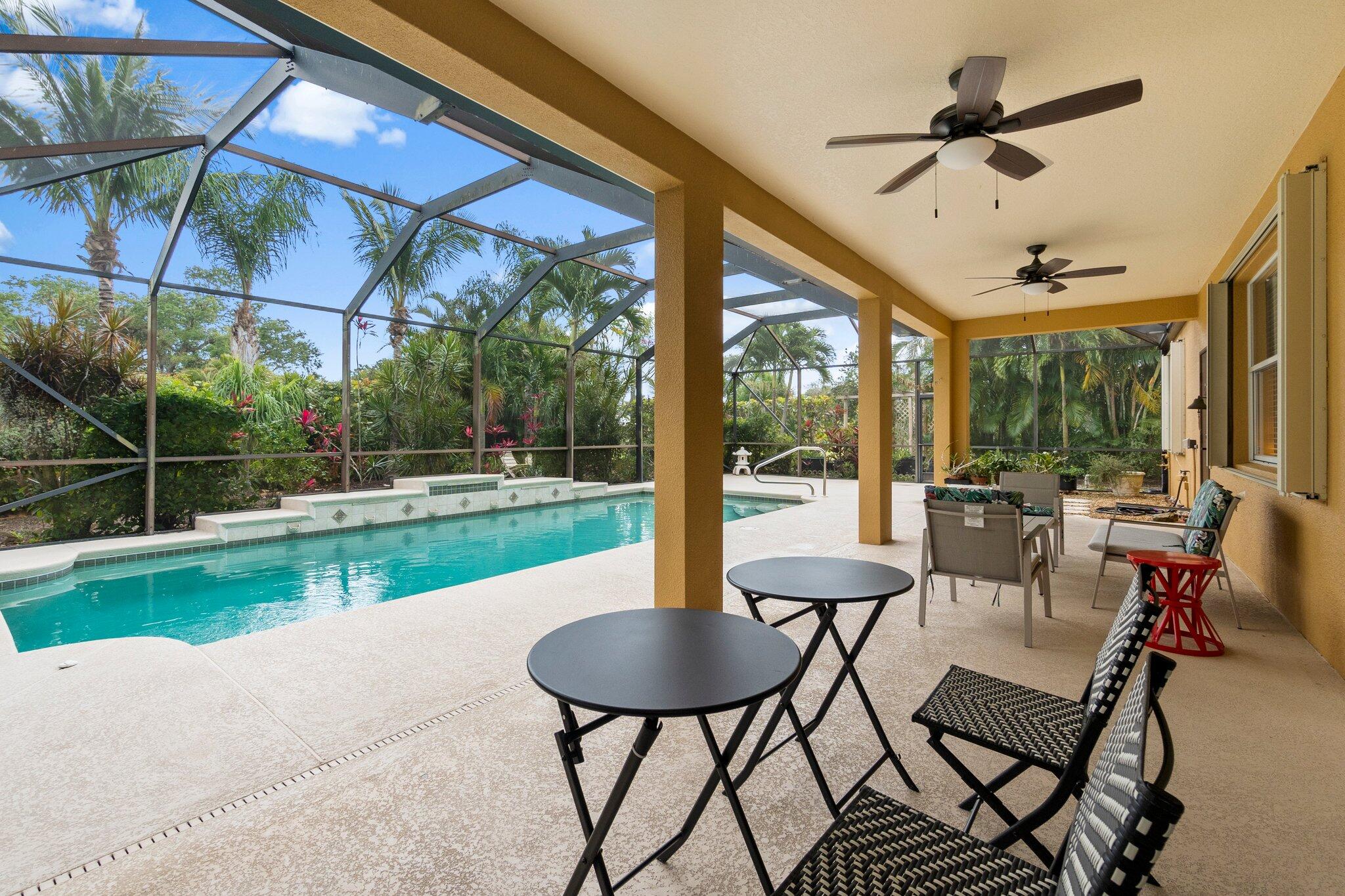 2309 Southwest Ivory Road Port St. Lucie, FL 34953 - Photo 37 of 46 a view of a patio with a table chairs and a backyard