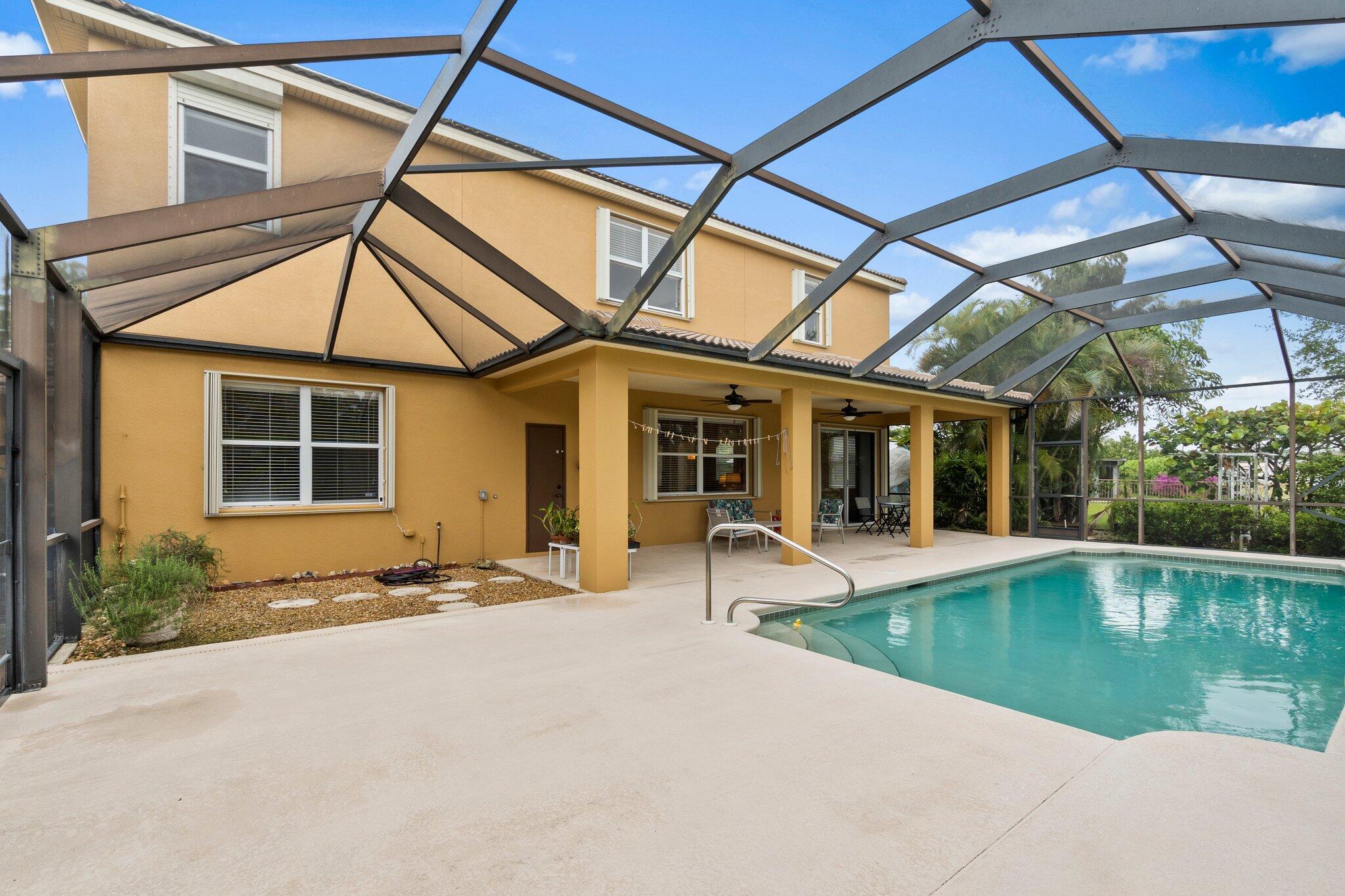 2309 Southwest Ivory Road Port St. Lucie, FL 34953 - Photo 38 of 46 a house with pool in front of it