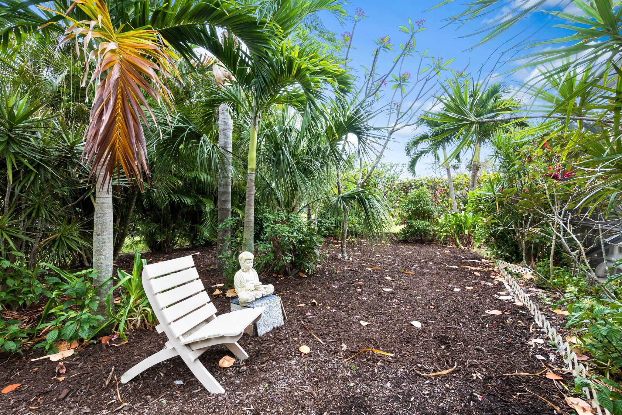 2309 Southwest Ivory Road Port St. Lucie, FL 34953 - Photo 40 of 46 a view of a yard with a chair and potted plants