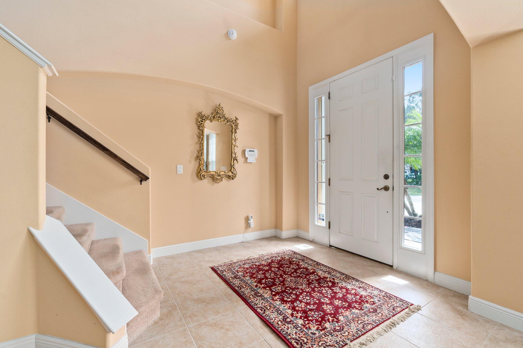 2309 Southwest Ivory Road Port St. Lucie, FL 34953 - Photo 4 of 46 a view of an entryway with wooden floor and a rug