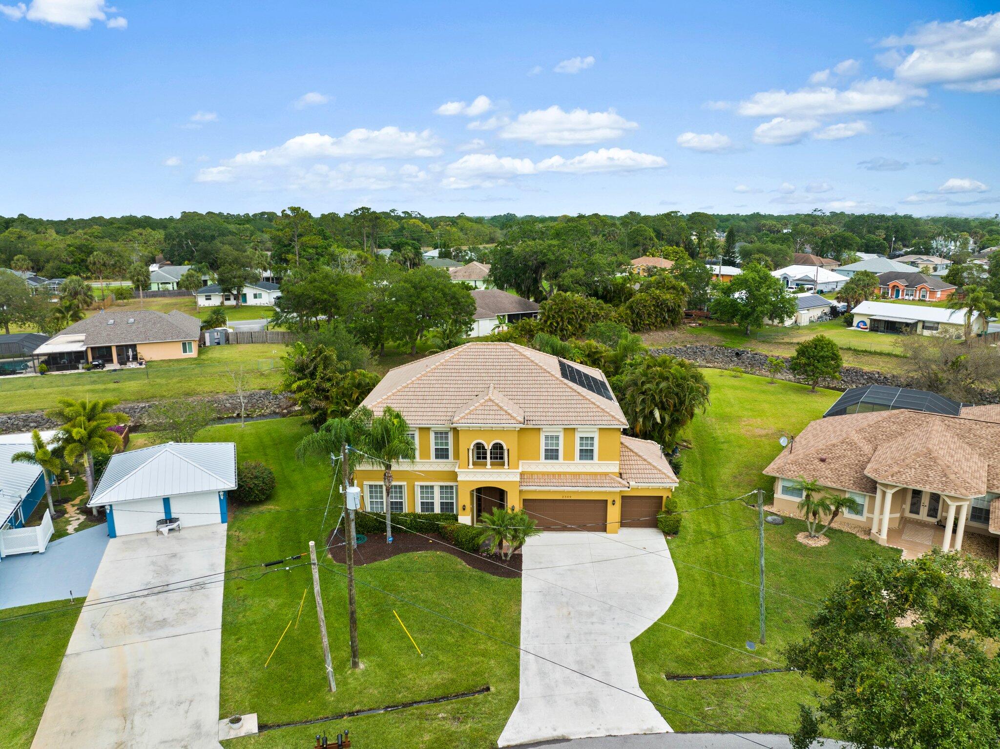 2309 Southwest Ivory Road Port St. Lucie, FL 34953 - Photo 41 of 46 an aerial view of a house with outdoor space lake view and houses in the back