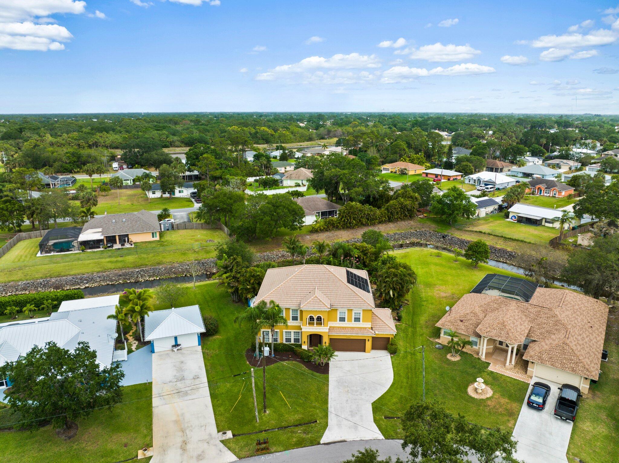 2309 Southwest Ivory Road Port St. Lucie, FL 34953 - Photo 42 of 46 an aerial view of a houses with a lake view