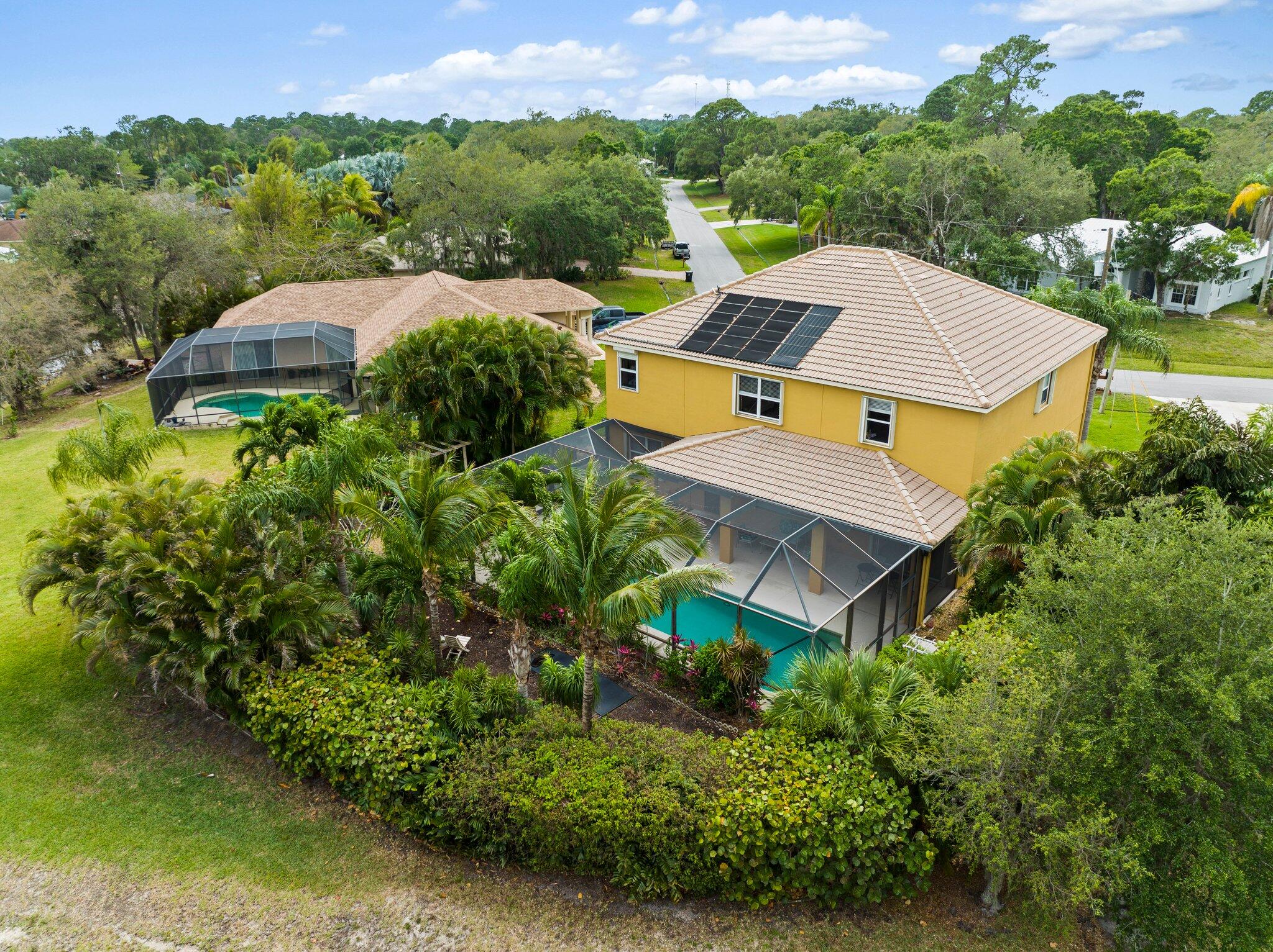 2309 Southwest Ivory Road Port St. Lucie, FL 34953 - Photo 43 of 46 an aerial view of a house with a yard and lake view