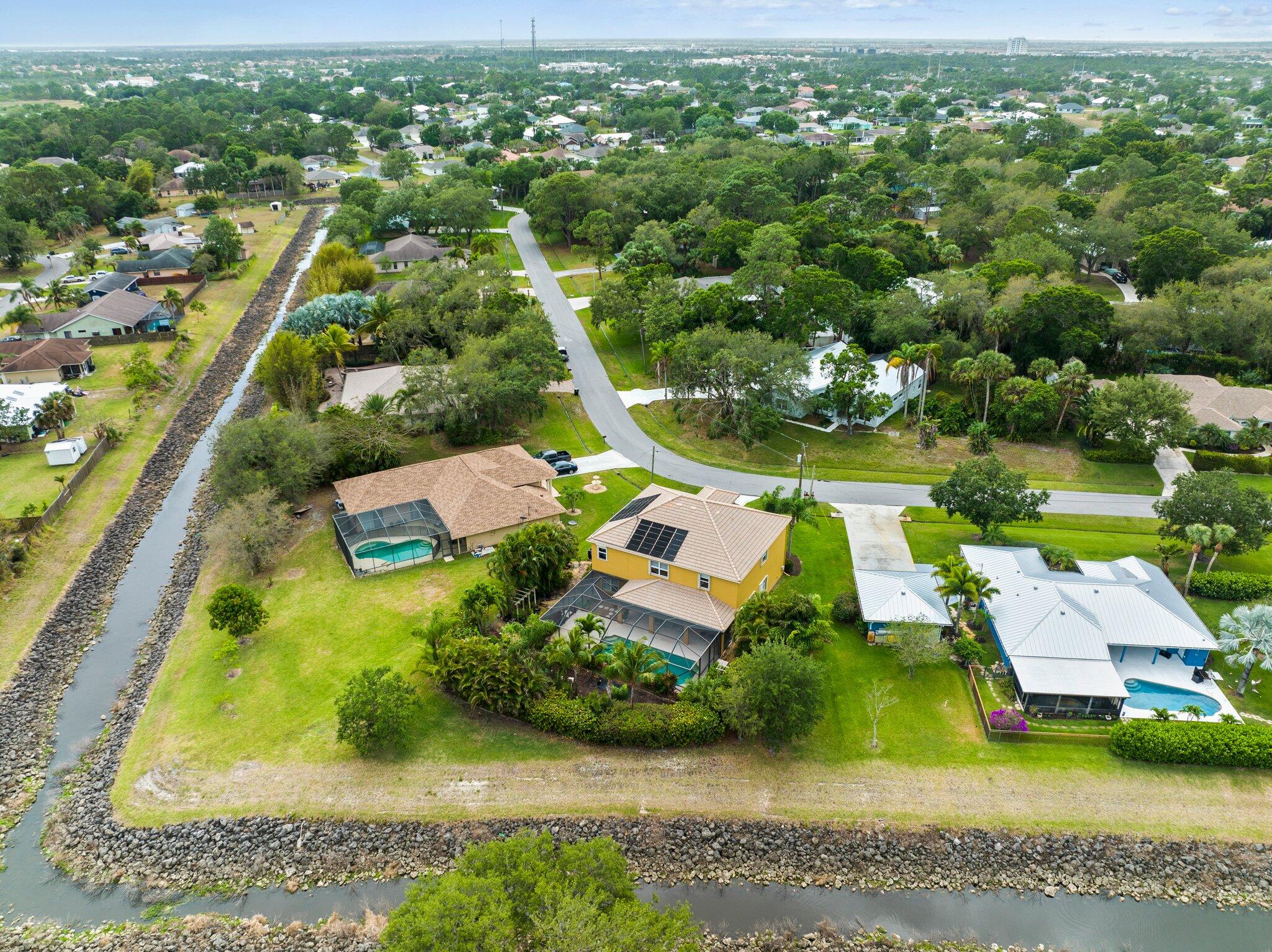 2309 Southwest Ivory Road Port St. Lucie, FL 34953 - Photo 44 of 46 an aerial view of residential houses with outdoor space and swimming pool
