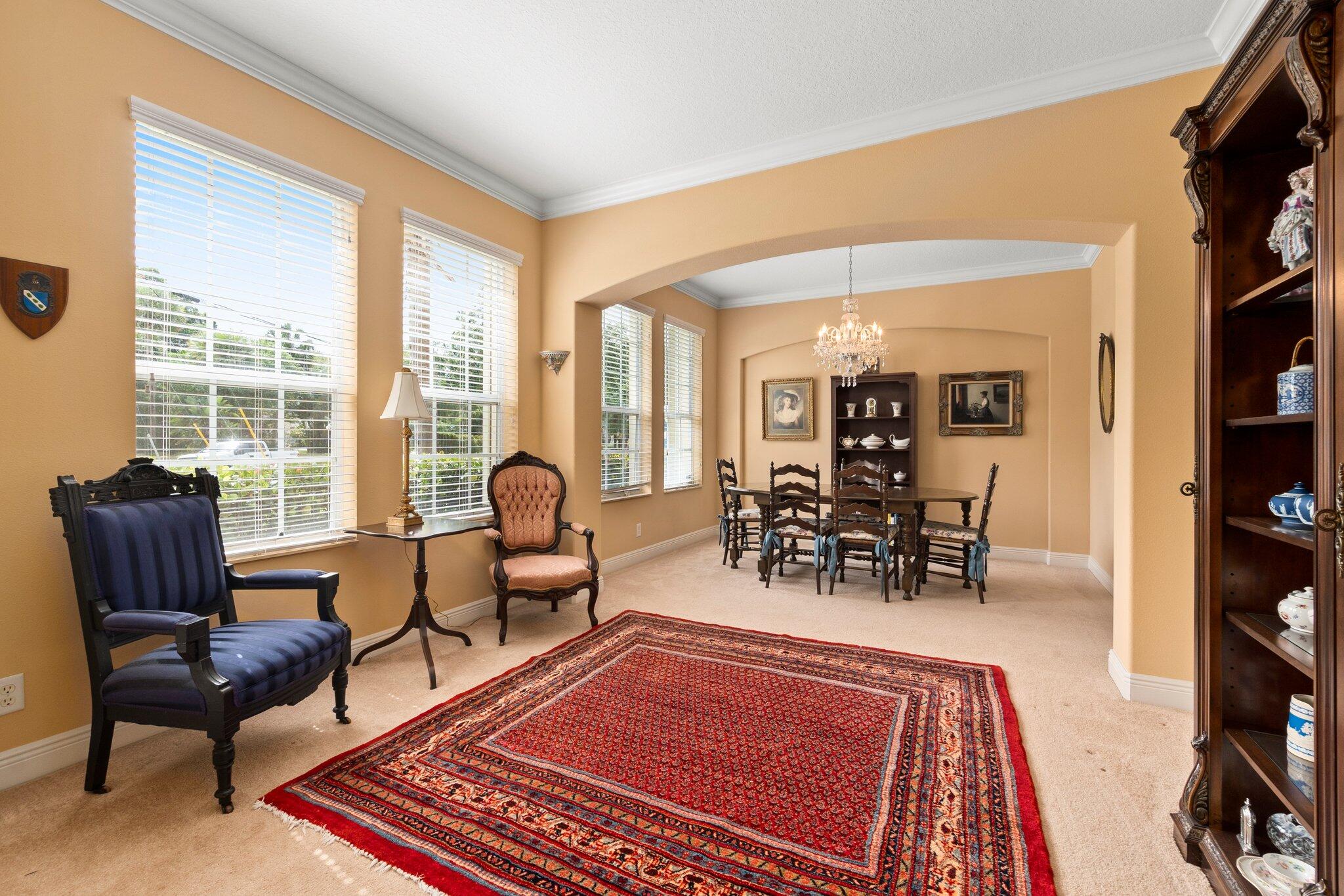 2309 Southwest Ivory Road Port St. Lucie, FL 34953 - Photo 6 of 46 a living room with furniture a rug and a floor to ceiling window