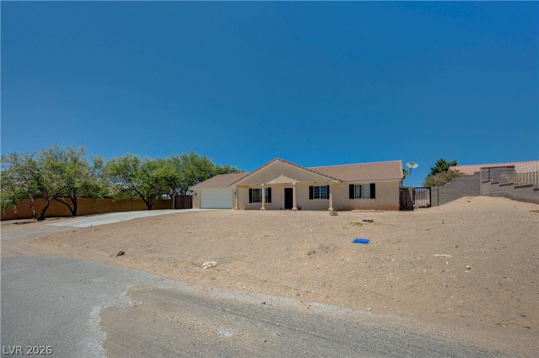 1272 Liston Avenue Logandale, NV 89021 - Photo 5 of 61 A desert oasis with a spacious front yard and inviting covered entry.