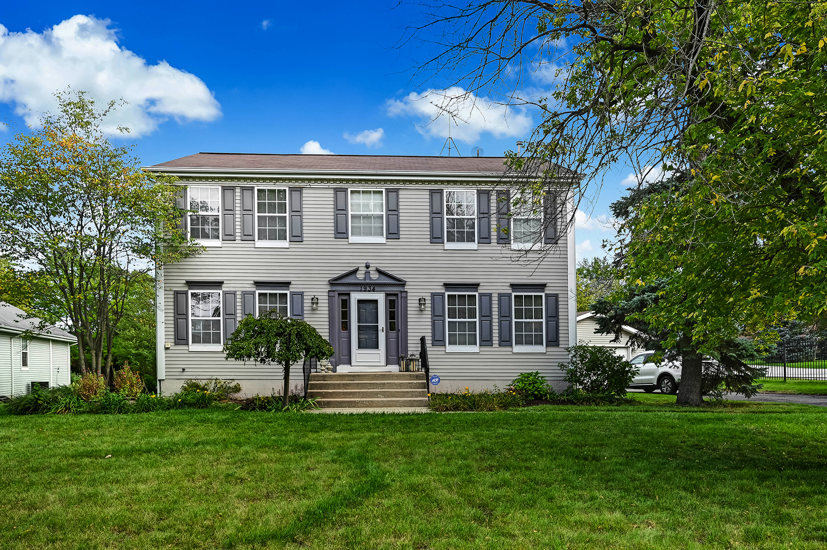 a front view of a house with a garden