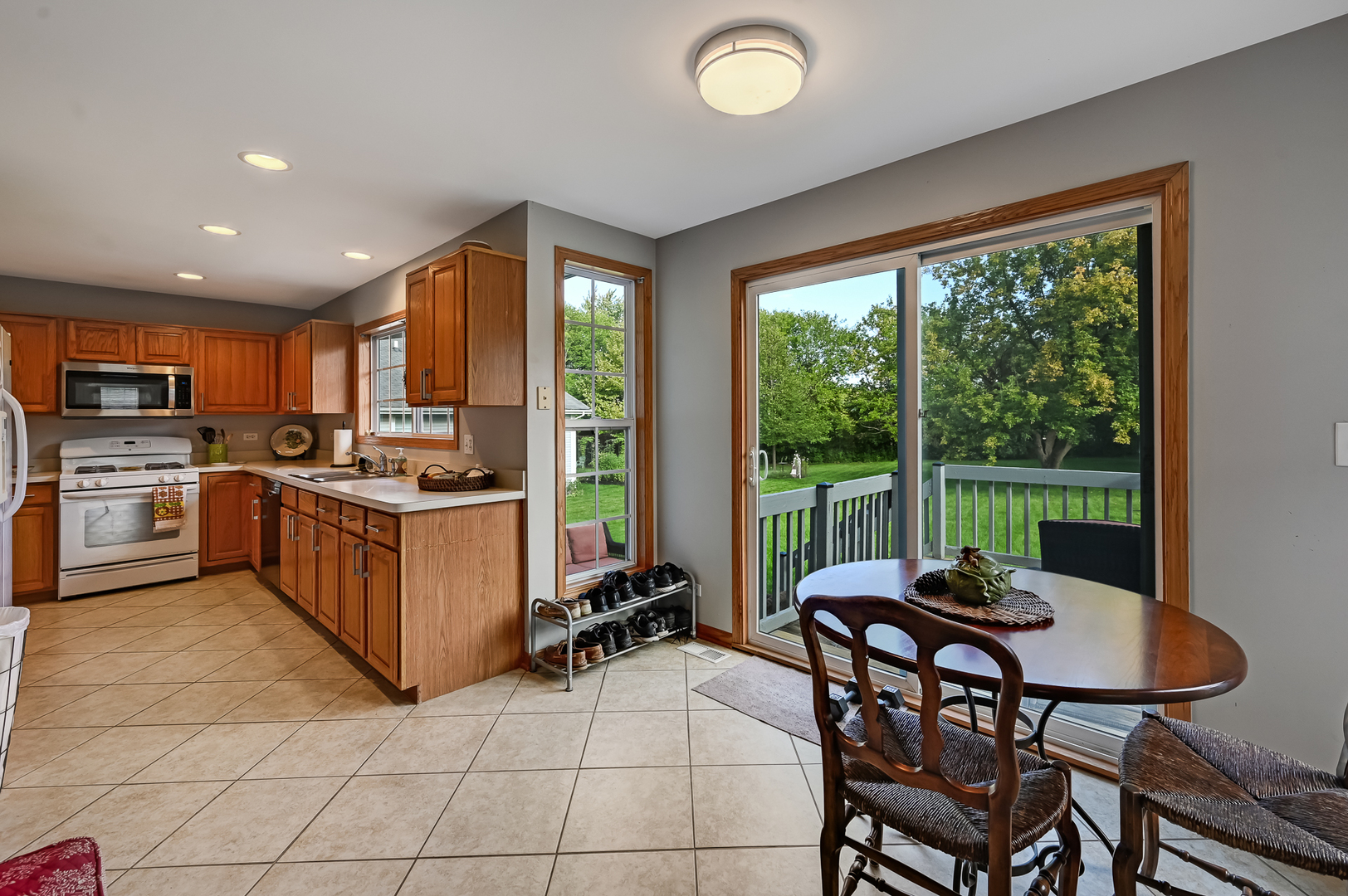1934 Manning Road Darien, IL 60561 - Photo 4 of 14 a kitchen with a table chairs microwave and cabinets