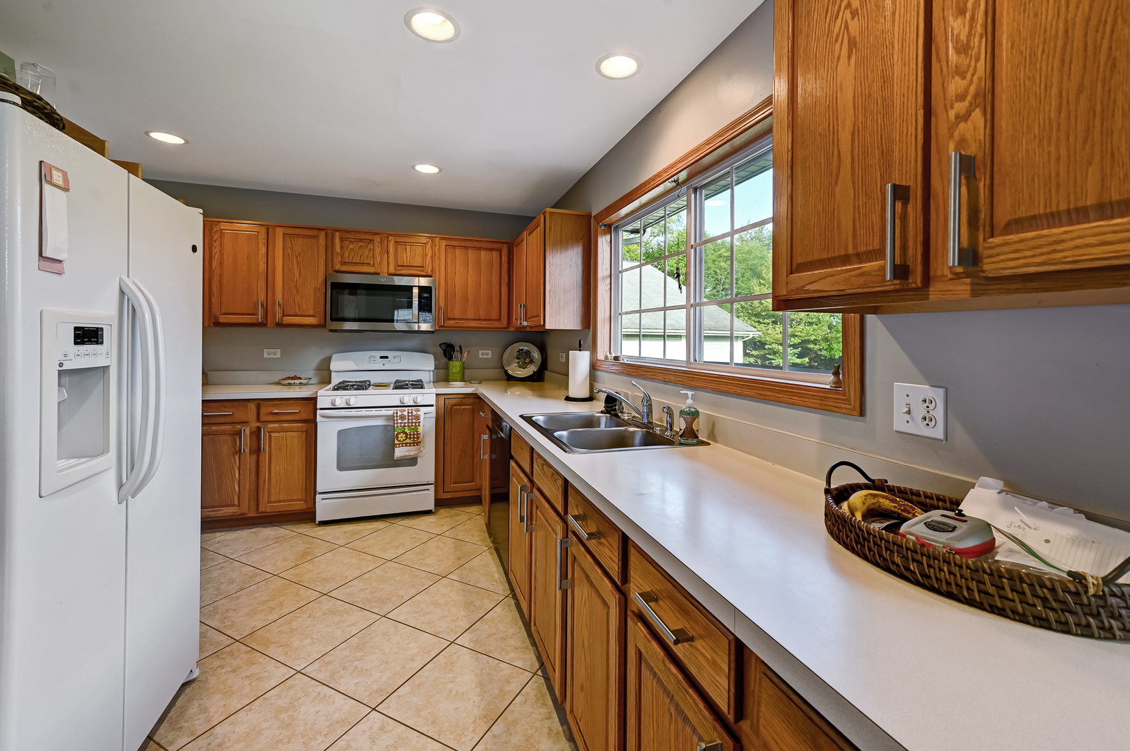 1934 Manning Road Darien, IL 60561 - Photo 5 of 14 a kitchen with kitchen island granite countertop a sink appliances cabinets and a counter top space