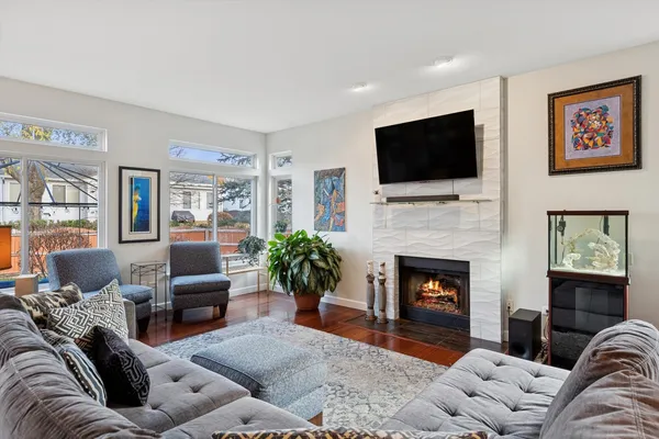 a living room with furniture a flat screen tv and a fireplace