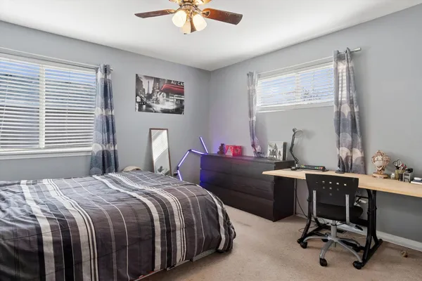 a bedroom with a bed and a desk