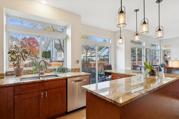 a kitchen with stainless steel appliances granite countertop a sink and a counter space