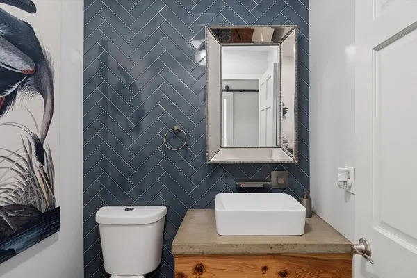 a bathroom with a toilet a sink and mirror