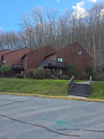 a front view of a house with a yard and a road