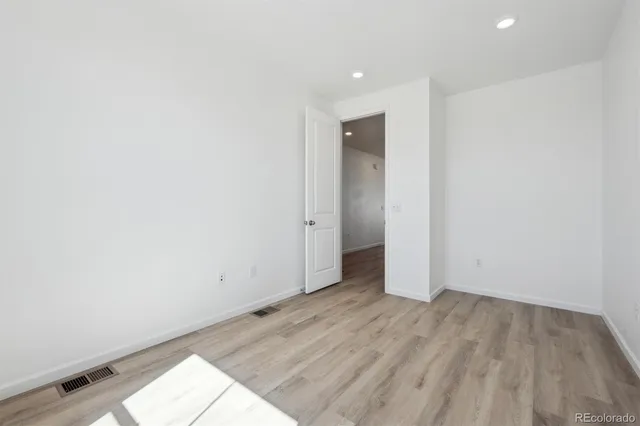 an empty room with wooden floor