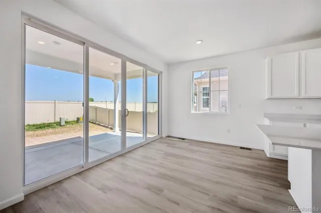 wooden floor in an empty room with a window