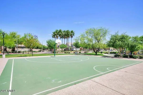 a view of a playground and basketball court