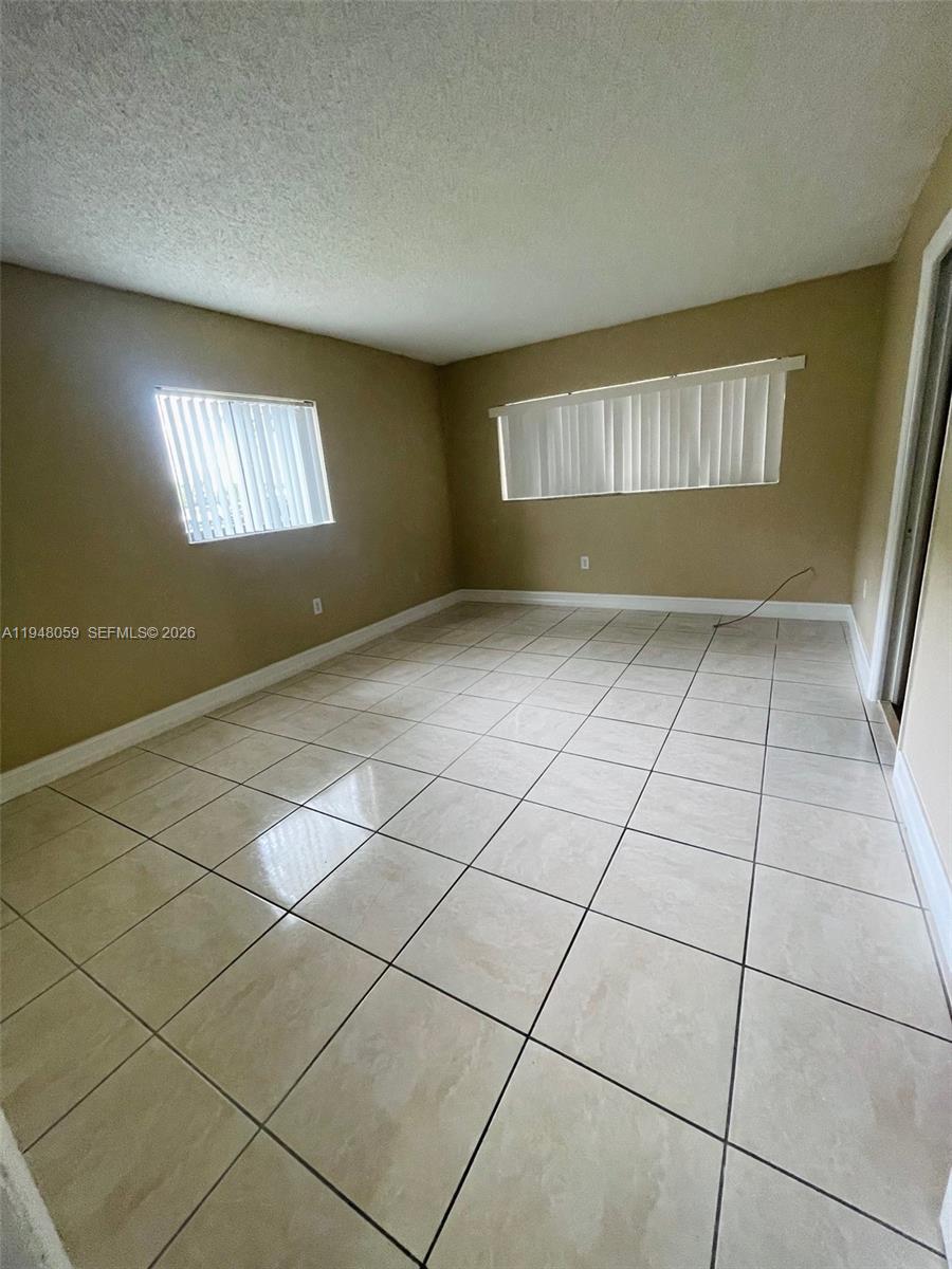 8400 Southwest 133rd Avenue Road, Unit 107 Miami, FL 33183 - Photo 15 of 21 a view of an empty room and window