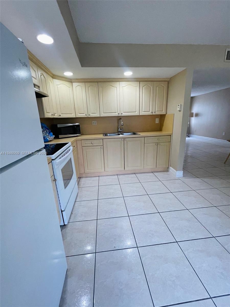 8400 Southwest 133rd Avenue Road, Unit 107 Miami, FL 33183 - Photo 5 of 21 a kitchen with a sink and cabinets