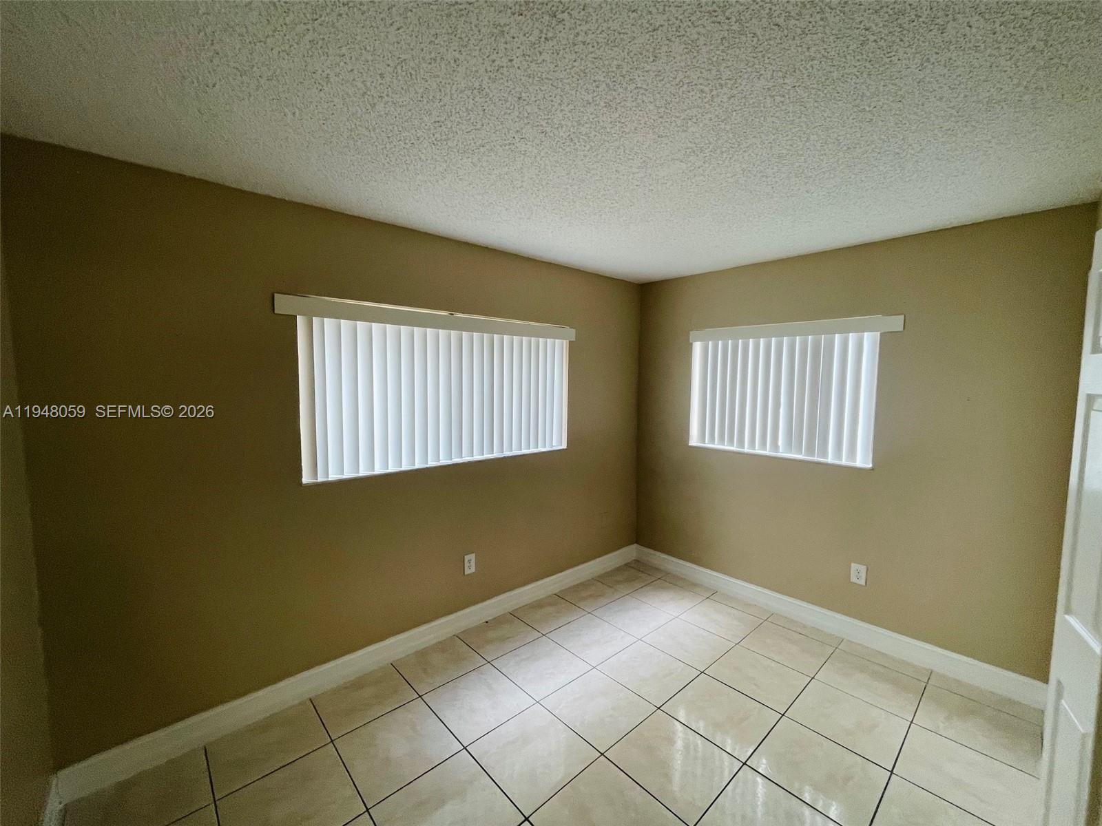 8400 Southwest 133rd Avenue Road, Unit 107 Miami, FL 33183 - Photo 6 of 21 a view of an empty room with window