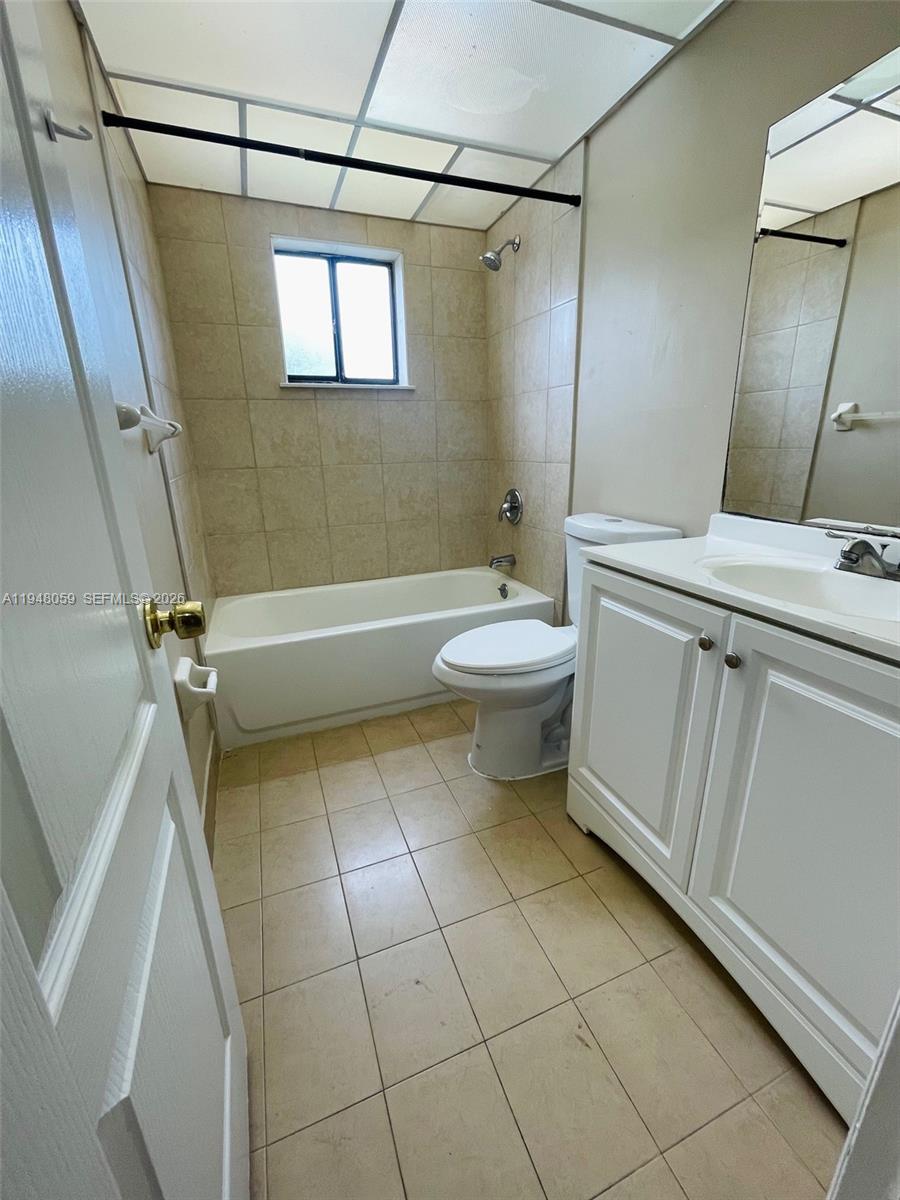 8400 Southwest 133rd Avenue Road, Unit 107 Miami, FL 33183 - Photo 7 of 21 a bathroom with a sink a toilet and shower