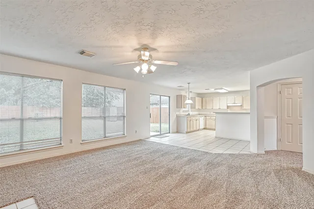a view of a livingroom with a chandelier fan