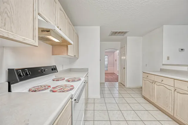 a view of a kitchen with a sink and a chandelier fan