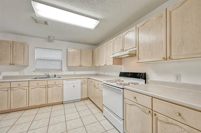 a front view of house with yard and trees