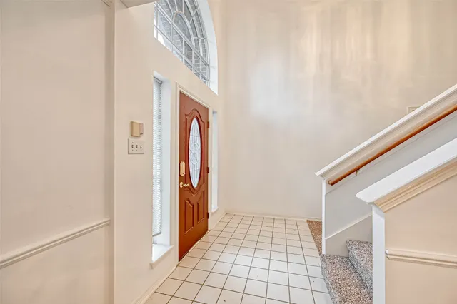 a view of a room with a windows and ceiling fan