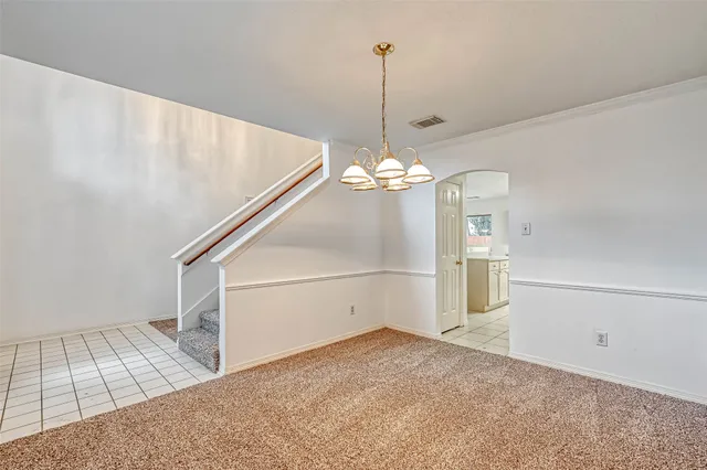 a view of an empty room with a fireplace and a window