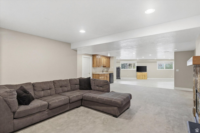 353 Robin Street Smithfield, UT 84335 - Photo 30 of 70 Living area featuring wet bar, light colored carpet, and recessed lighting