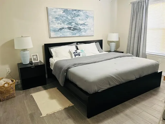 a bedroom with a bed and lamps