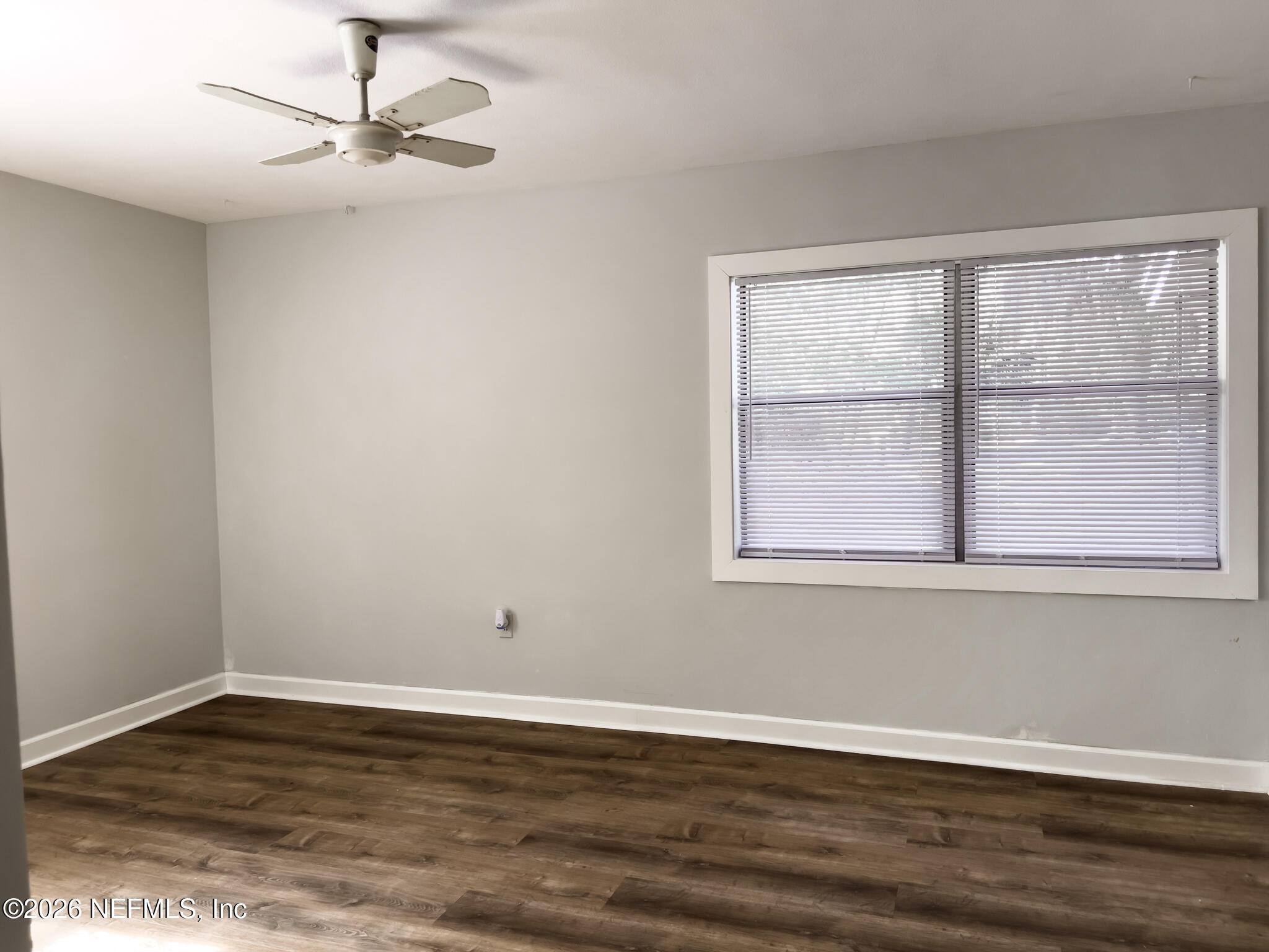 2085 Mills Road Jacksonville, FL 32216 - Photo 7 of 13 a view of empty room with wooden floor and fan