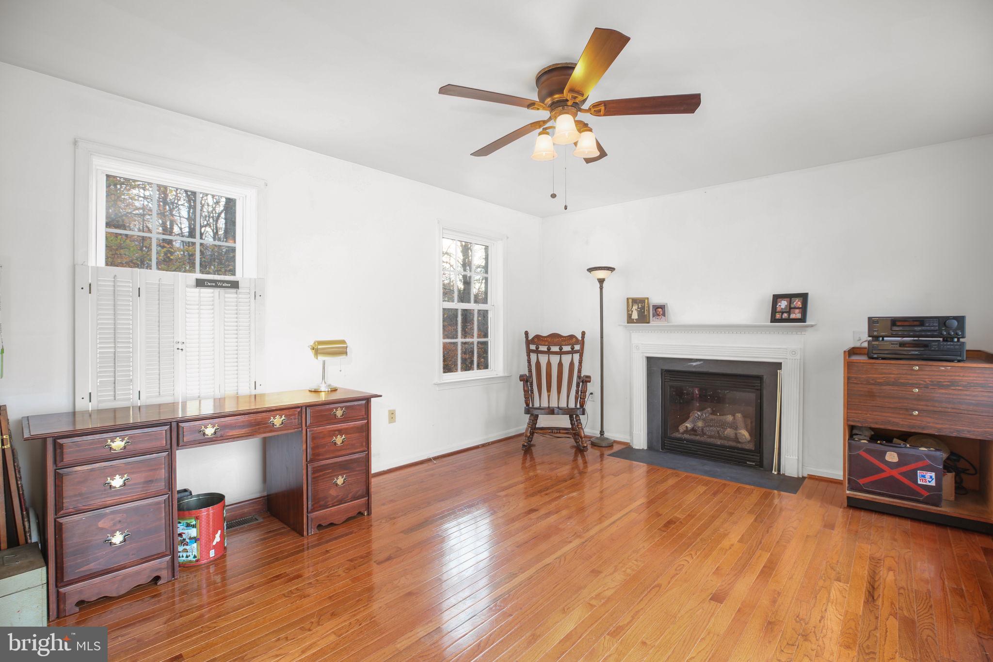 315 Sandy Ridge Road Fredericksburg, VA 22405 - Photo 15 of 42 a living room with furniture and a fireplace