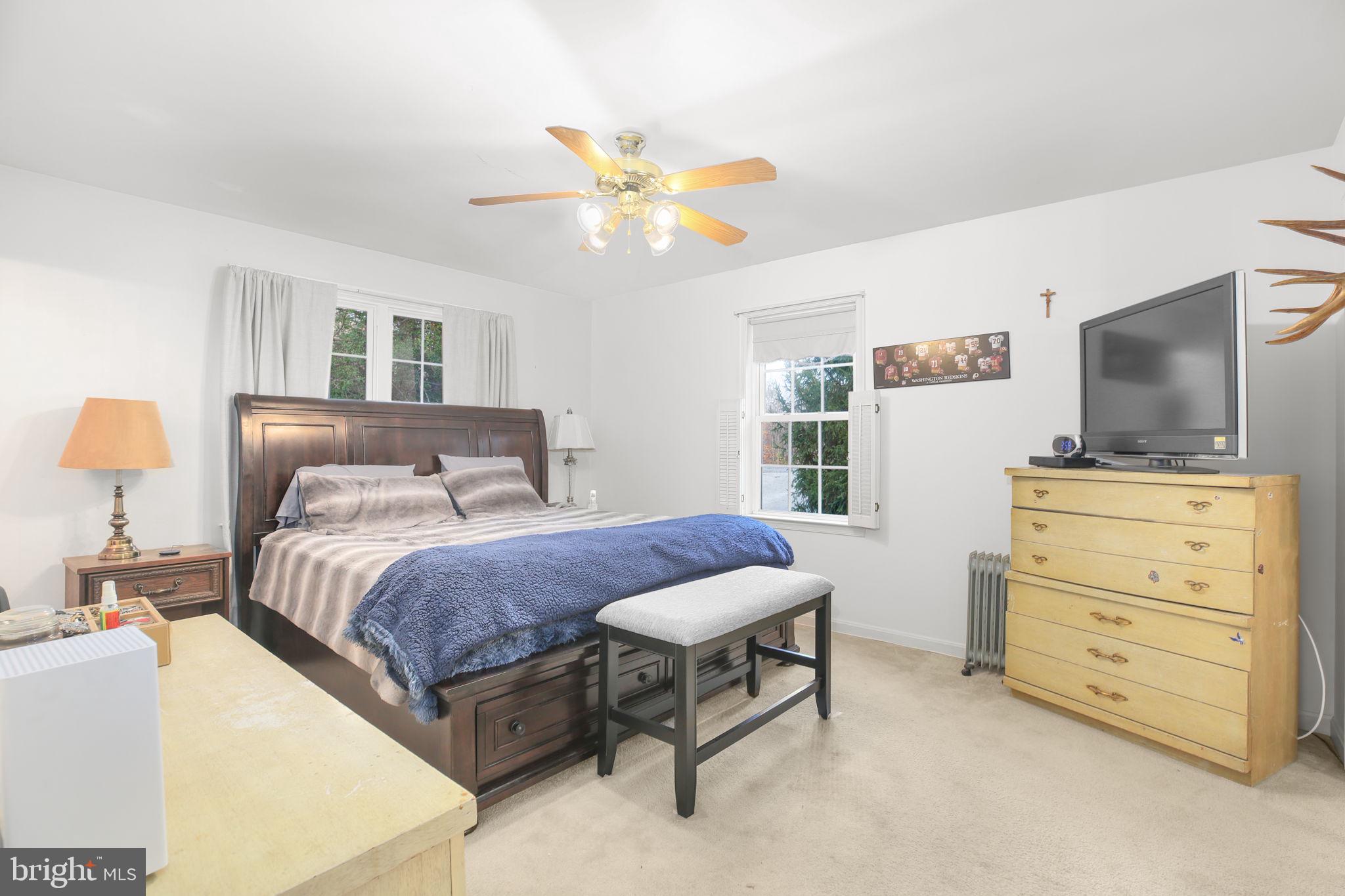 315 Sandy Ridge Road Fredericksburg, VA 22405 - Photo 16 of 42 a bedroom with a bed and a flat screen tv