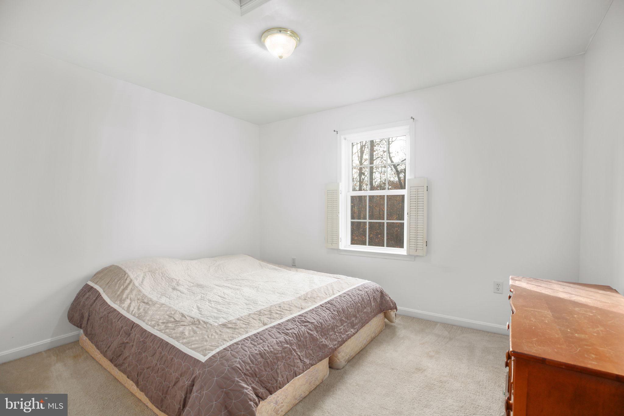315 Sandy Ridge Road Fredericksburg, VA 22405 - Photo 19 of 42 a bedroom with a bed and window