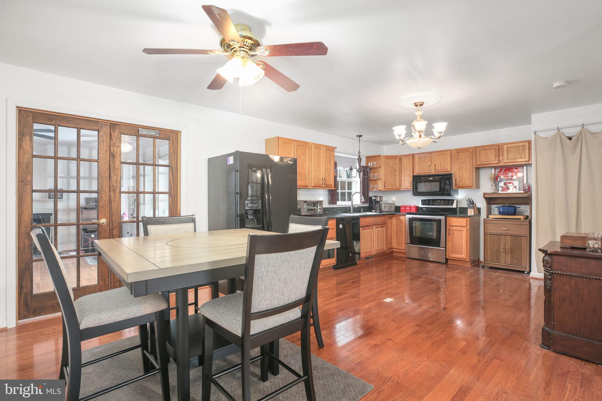 315 Sandy Ridge Road Fredericksburg, VA 22405 - Photo 7 of 42 a view of a dining room and livingroom with furniture wooden floor a chandelier