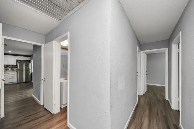 a view of a hallway with wooden floor