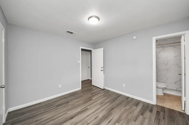 a view of an empty room and wooden floor