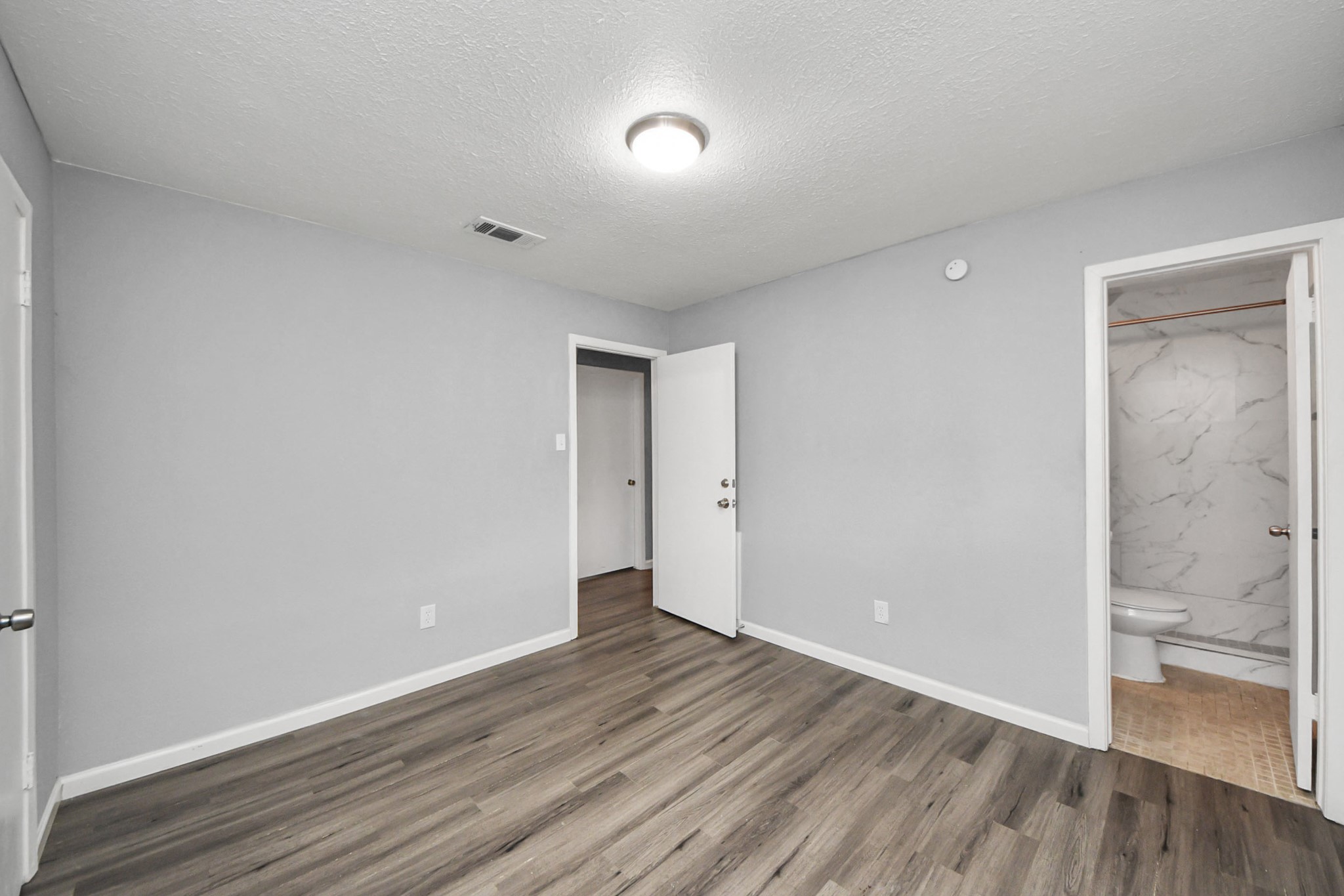 11510 Lockgate Lane Houston, TX 77048 - Photo 16 of 22 a view of an empty room and wooden floor