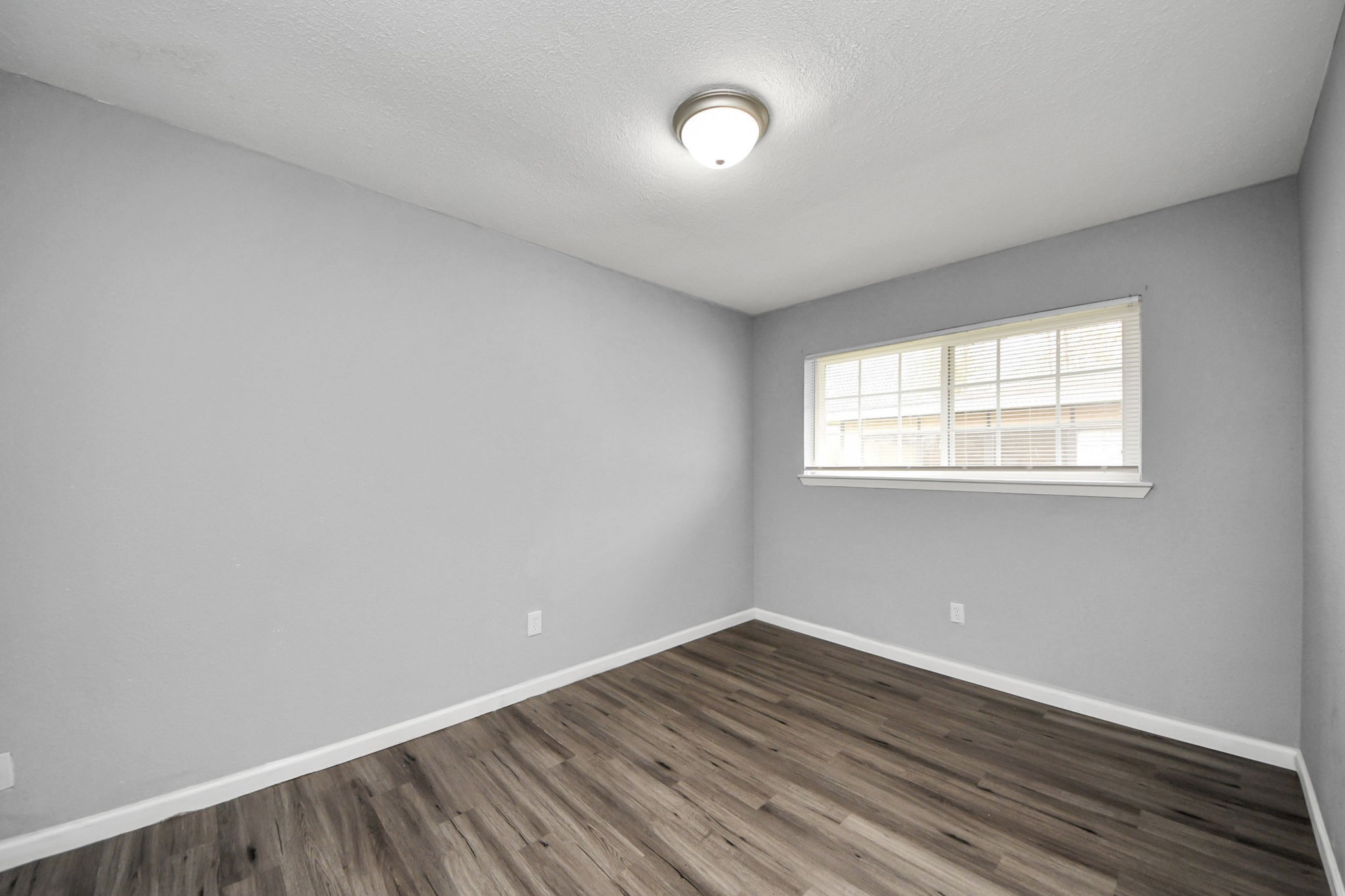 11510 Lockgate Lane Houston, TX 77048 - Photo 19 of 22 a view of an empty room with wooden floor and a window