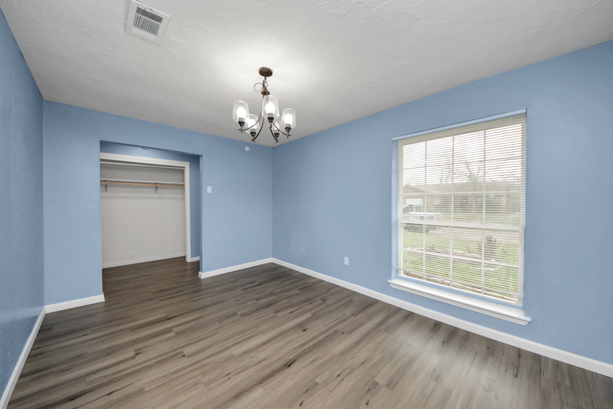 11510 Lockgate Lane Houston, TX 77048 - Photo 4 of 22 a view of an empty room with wooden floor and a window