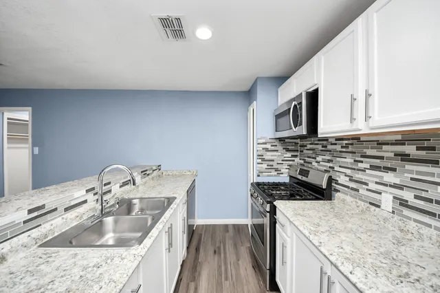 a kitchen that has a sink and a stove