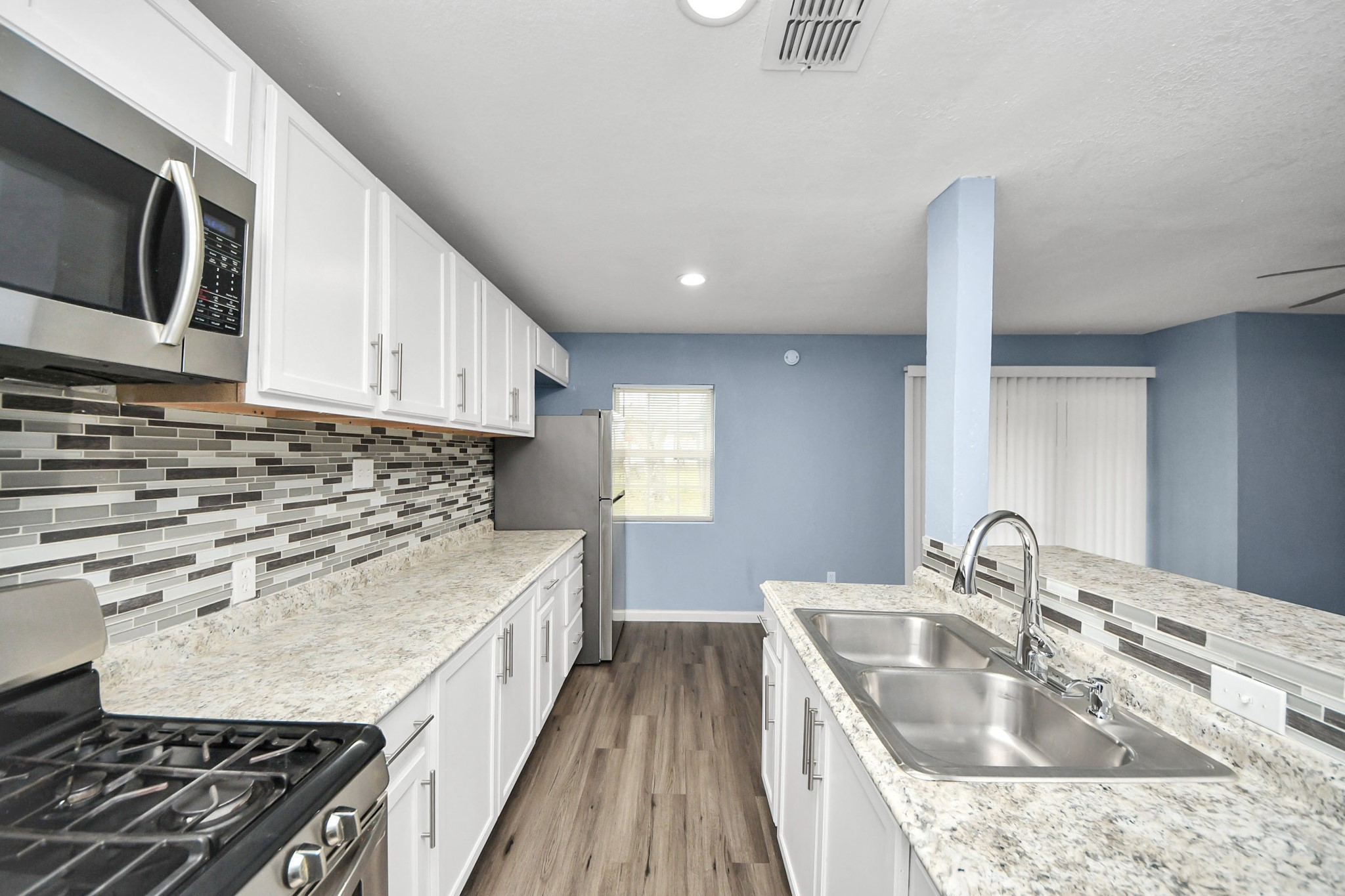 11510 Lockgate Lane Houston, TX 77048 - Photo 9 of 22 a kitchen with a sink stove and microwave